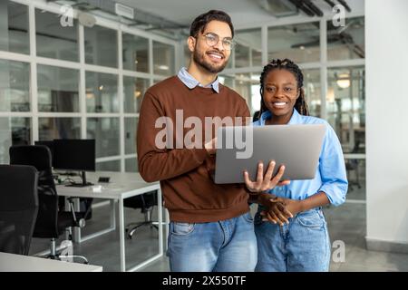 Diverse colleagues collaborating on project together Stock Photo