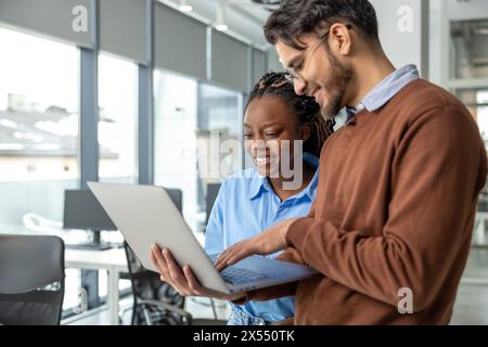 Diverse colleagues collaborating on project together Stock Photo