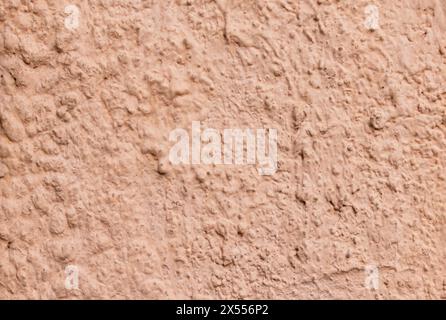 Abstraction. Texture of cement plastered and painted wall in pale pink color closeup Stock Photo