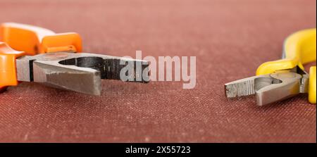 Set of wire cutters of different sizes close-up on workbench background Stock Photo