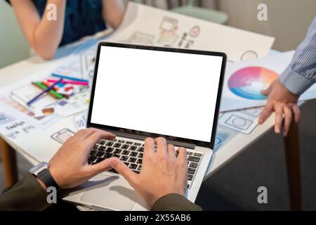 Website designer, Creative planning phone app development template layout framework wireframe design, Young asian man UX designer working on laptop Stock Photo