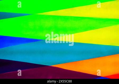 A fragment of colorful graffiti painted on a wall. Abstract urban background for design. Spray painting art. Stock Photo