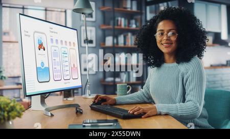Latina Female Specialist Working on Desktop Computer at Home Living Room while Sitting at a Table. Freelancer Developing New Food Delivery App Design, User interface in a Graphics Editing Software. Stock Photo