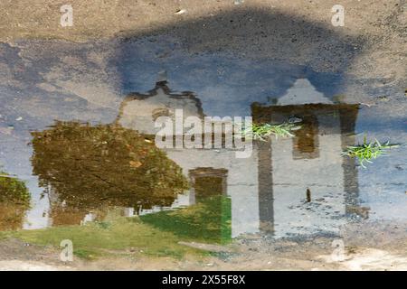 Reflection in a puddle of rainwater from a Catholic church and a tree. Bahia Brazil. Stock Photo