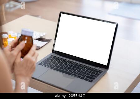 Elderly woman sit at home having online consultation with doctor on computer laptop, sick senior talk on video call consulting with nurse using laptop Stock Photo