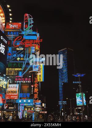 Bustling Nightlife Scene in Urban City With Neon Signboards and Illuminated Skyscrapers / ChangSha Hunan China Stock Photo