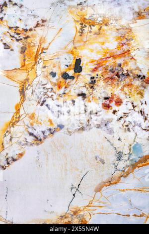 Beautiful texture of old marble with brown splashes of orange onyx, abstract pattern of old stone in section. Stock Photo