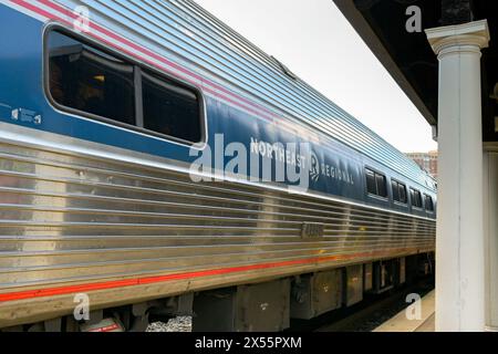 Alexandria, Washington DC, USA - 1 May 2024: Side view of a coach on an Amtrak Northeast regional express train at the town's railway station. Stock Photo