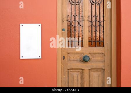 Rectangular mockup of outdoor business signboard on the wall by the entrance door Stock Photo