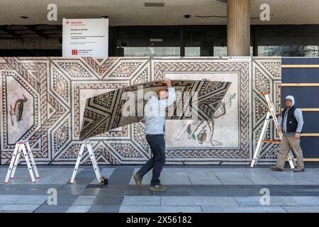 a reproduction with excerpts from the Dionysus mosaic is mounted on the construction fence of the Roemisch-Germanisches Museum on Roncalliplatz, Colog Stock Photo