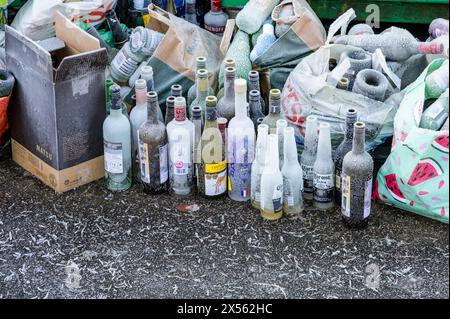 Frozen glass wine bottles waiting to be collected at a council recycling area in winter, Glasgow, Scotland, UK, Europe Stock Photo