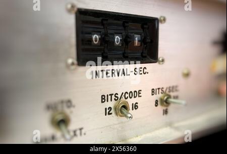 A retro vintage analog display with toggle switches to set intervals per second, with switches for bits per code and bits per second Stock Photo