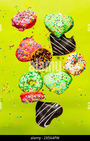 Multicolored donuts isolated on yellow background. Top view Stock Photo