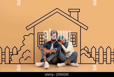 Eastern Spouses Sitting on the Floor in Front of House Stock Photo
