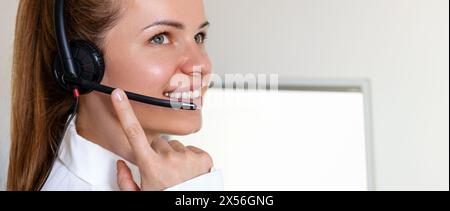 Woman office worker in headset. Customer service or hotline representative. Helpdesk. Stock Photo