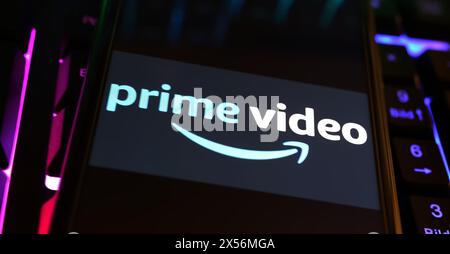 Viersen, Germany - May 1. 2024: Closeup of smartphone with logo lettering of Amazon Prime Video streaming service on computer keyboard Stock Photo