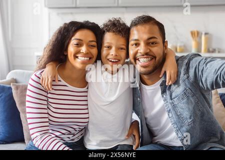 Black Family Taking a Selfie on the Couch Stock Photo