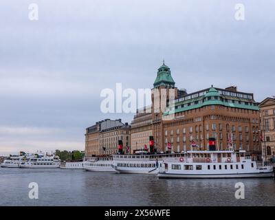 Stockholm, Sweden - May 21 2022: Feries moored in front of historical buildings. No visible people. Stock Photo