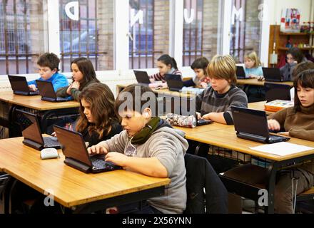 11 year old pupils using laptop computers, 5º de ESO, Ikastola Zurriola, San Sebastian, Guipuzcoa, Basque Country, Spain Stock Photo