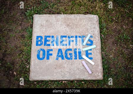 BENEFITS OF AGILE. Colored pieces of chalk on a concrete pavement slab. Stock Photo