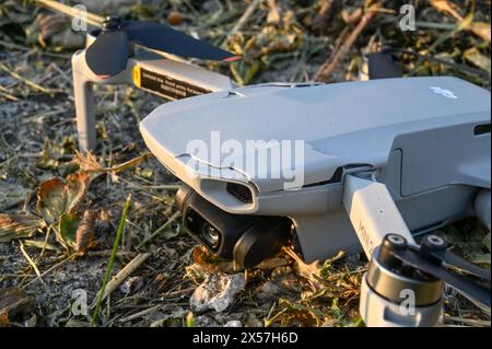 Crashed and damaged drone. Broken arms and camera gimbal of drone. Drone fell to the ground. Accident during flight. Stock Photo