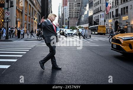 New York, USA. 08th May, 2024. A man wearing a mask of former US President Donald Trump stands on the street in New York. Credit: Britta Pedersen/dpa/Alamy Live News Stock Photo