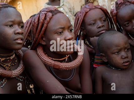 Group of Himba children and young woman look at pictures on a camera, near Opuwo, Kaokoveld, Kunene, Namibia Stock Photo