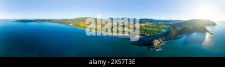 Panoramic aerial view of a green forested coastal landscape with blue sea and sky, Pochote, Puntarenas, Costa Rica Stock Photo