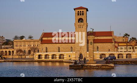 Reflection of a church in calm water under the golden sky of the morning, Church of the Annunciation of the Blessed Virgin Mary, bell tower, harbour Stock Photo