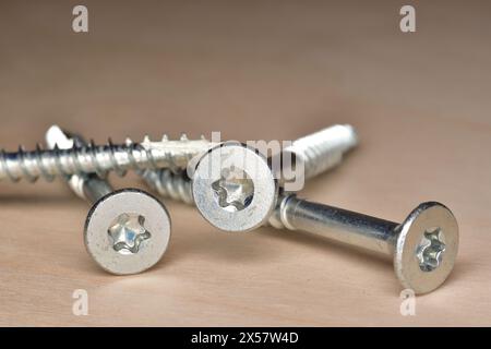 Zinc plated flat head wood screws. Torx socket coarse thread wood screws. Stock Photo