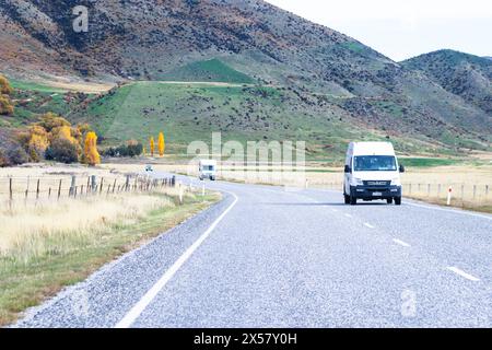 Central Otago, New Zealand - April 21, 2023: Vehicles travelling through the Lindis Pass Alpine Highway, New Zealand. Stock Photo