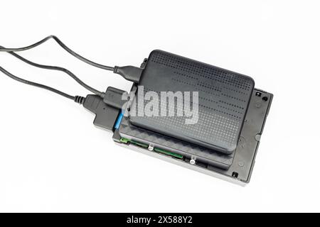 Portable hard disk drives connected to computer isolated on white background. top view. Stock Photo