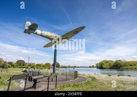 A replica Spitfire fighter aircraft from WW2 pictured on the edge of Fairhaven Lake in Lytham, Lancashire on 5 May 2024. Stock Photo