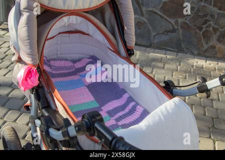 on the street near the house is an empty stroller Stock Photo