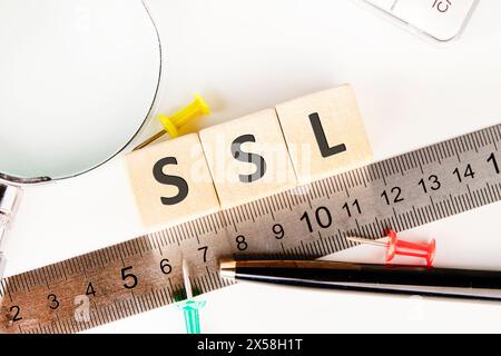 SSL (Secure Sockets Layer) text written on wooden cubes next to the ruler Stock Photo