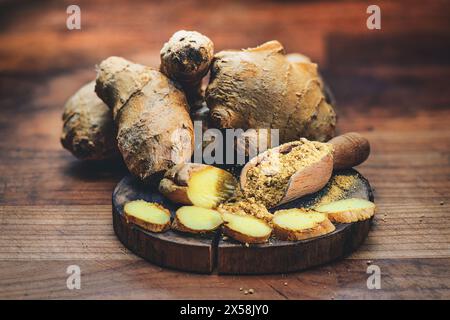 Ginger root with powder on cutting board Stock Photo