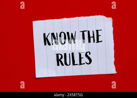 Know the rules words written on ripped paper with red background. Conceptual know the rules symbol. Copy space. Stock Photo