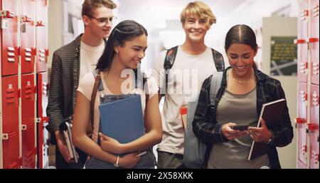 High school, students and friends group in hallway at education campus for learning, academic or cellphone. Boys, girls and books at lockers for Stock Photo