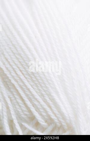 Close-up on the threads of a ball of white wool Stock Photo