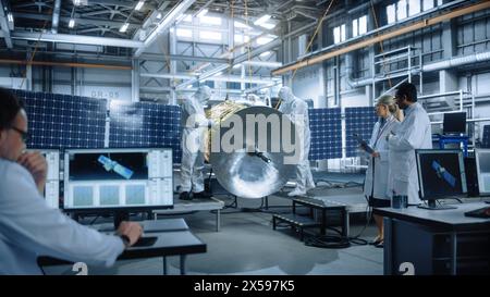 Team of Engineers Working on Satellite Construction, Use Tablet Computer Talk about Data. Aerospace Spaceship Manufacturing Facility: Team of Scientists Building Spacecraft for Space Exploration Stock Photo