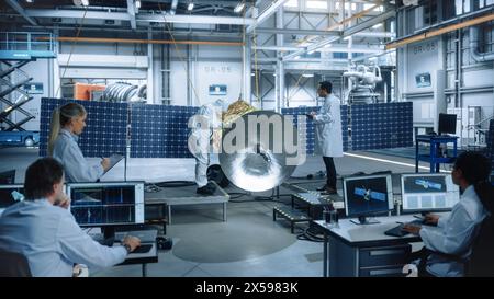Team of Engineers Working on Satellite Construction. Aerospace Agency Spaceship Manufacturing Factory: Diverse Group of Multi-Ethnic Scientists Developing Spacecraft for International Space Program Stock Photo