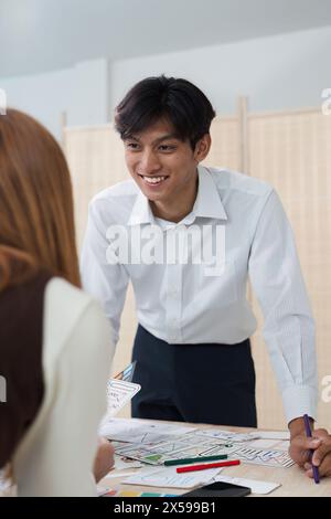 Close up ux developer and ui designer brainstorming interface wireframe design.Creative digital development agency Stock Photo