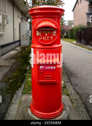An traditional old Japanese red letter box in the town of Kanazawa Stock Photo