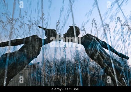Kharkiv, Ukraine - April 10, 2021 .Cultural object Monument to Lovers. The monument in love on the background of the fountain jets and cloudy sky Stock Photo