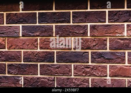 Weathered texture of stained old dark brown and red brick wall background, grungy rusty blocks of stone-work technology, colorful horizontal Stock Photo