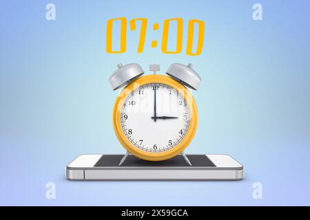 Yellow alarm clock showing 7 am on phone Stock Photo