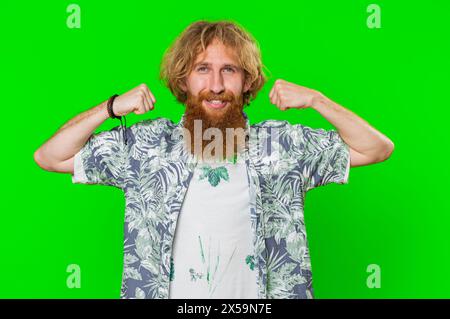 I am strong and independent. Young bearded man showing biceps and looking confident, feeling power strength to fight for rights, energy to gain success win. Guy isolated on green chroma key background Stock Photo