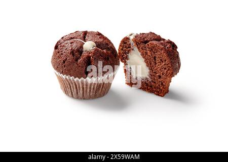 Whole and sliced chocolate muffins with creamy filling Stock Photo