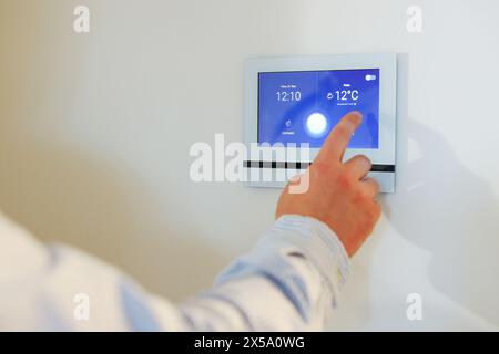 Man entering code on home security system, closeup Stock Photo