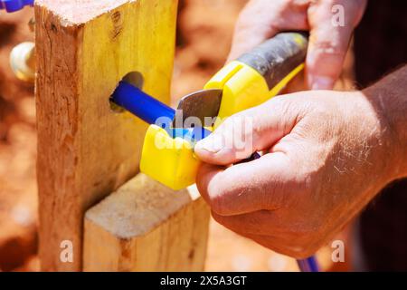Water piping is cut with saw tool by plumber using blue plastic PVC water piping Stock Photo